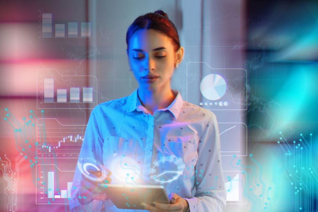 Professional employee using a digital tablet while reviewing AI-generated analytics and business insights.